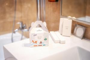 a bottle of soap sitting on top of a bathroom sink at BRISTOL Hotel Opatija in Opatija