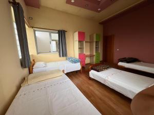 a room with three beds and a desk in it at Apartment 189 in Tirana +44 photos