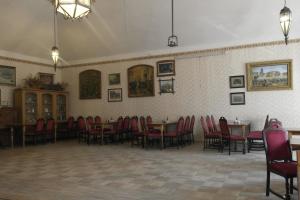 a dining room with tables and red chairs at Hotel u Jindry in Železnice