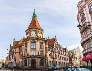 a building with a clock tower on top of it at PETiT MULHOUSE 201 in Mulhouse