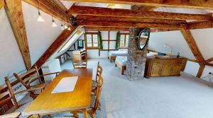 a dining room with a table and a stone fireplace at Haan-Ferienwohnung in Haan