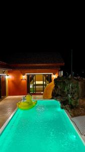 a swimming pool with a toy in the water at MARENA Poolvilla UdonThani in Udon Thani