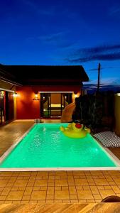 a swimming pool with a toy in the middle at MARENA Poolvilla UdonThani in Udon Thani