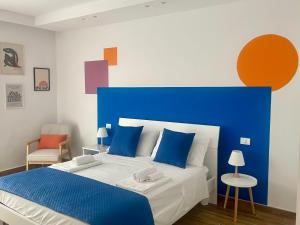 a blue and white bedroom with a large bed at Borgo Minore in Montefiascone