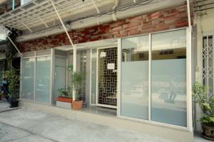 a building with large glass windows and plants in it at Nine Place Sukhumvit 40 in Bangkok