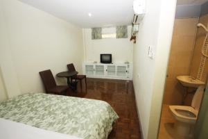 a bedroom with a bed and a bathroom with a sink at Nine Place Sukhumvit 40 in Bangkok +41 photos