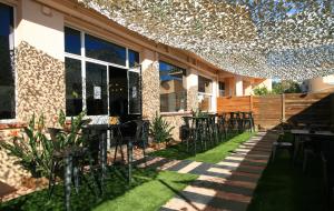 a patio with tables and chairs in front of a building at Hostellerie LE PANEL in Mandelieu-la-Napoule