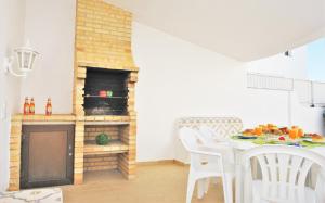a living room with a table and a fireplace at Villa Ibiza by Algarve Vacation in Guia
