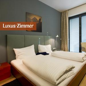 Letto o letti in una camera di Hotel Lava Inn - 24 h Check-In - Nähe LKH, Landeskrankenhaus, Feldbach