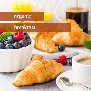 a table with croissants and a cup of coffee and fruit at Hotel Lava Inn - 24 h Check-In - Nähe LKH, Landeskrankenhaus, Feldbach in Feldbach