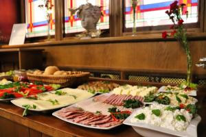 a buffet with plates of food on a table at Hotel Polonia Centrum in Wrocław
