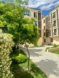 a tree in front of a building at Orden Hotel in Tbilisi City