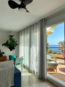 a bedroom with a bed and a view of the ocean at Can Luc Altea in Altea