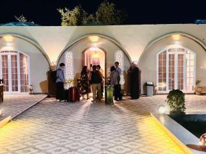 a group of people standing outside of a building at West Bank luxury villa in Luxor