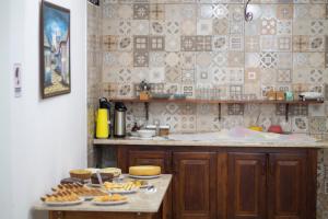 a kitchen with cookies and pastries on a table at Pousada Nativos Lençois in Lençóis