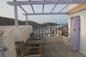 a balcony with a table and a view of the ocean at Panormos Apartments in Panormos