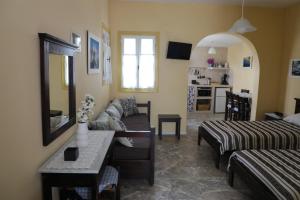 a living room with a couch and a table at Panormos Apartments in Panormos