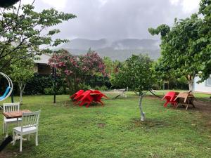 a group of red tables and chairs in a yard at Çıralı Marina Loft in Cıralı