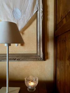 a lamp sitting on a table next to a window at La Locanda Del Tevere in Fiano Romano