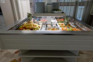 a refrigerator filled with lots of fruits and vegetables at Hotel Continental in Caorle