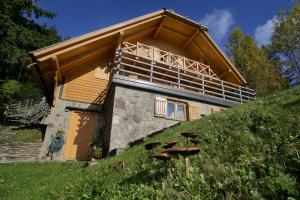 a building on top of a grassy hill at Charming Chalet Rogla in Hudinja