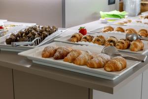 a buffet of pastries and croissants on a table at Hotel Continental in Caorle