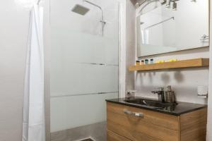 a bathroom with a sink and a mirror at Sunset Horizon Villa in Aggelika