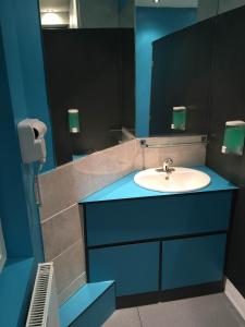 La salle de bains est pourvue d'un lavabo et d'un miroir. dans l'établissement Book A Bed Hostels, à Londres