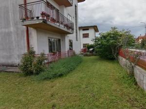 a house with a balcony and a grass yard at Flavia in Cividale del Friuli