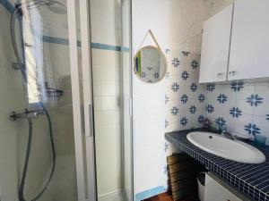a bathroom with a shower and a sink at Studio Cocody 49 LUMIO in Lumio