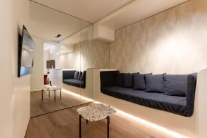 a living room with a couch and a table at DuoMo Hotel in Rimini