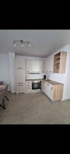 a kitchen with white cabinets and a stove top oven at Apartman Emily2 Dramalj in Dramalj