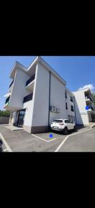a white car parked in front of a building at Apartman Emily2 Dramalj in Dramalj +2 photos