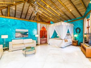 ein Schlafzimmer mit einem Bett und einem Sofa in der Unterkunft DPNY Beach Hotel & SPA Ilhabela in Ilhabela