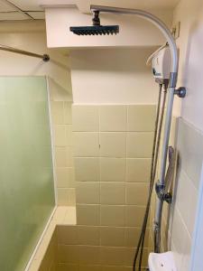 a shower in a bathroom with a toilet and a shower head at Marvee’s Haven Tagaytay Staycation in Tagaytay +5 photos