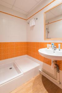 W łazience znajduje się umywalka i wanna. w obiekcie Résidence Pierre & Vacances la Corniche de la Plage w mieście Bénodet