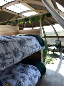 a room with two bunk beds in a tent at Hoot in Abergele