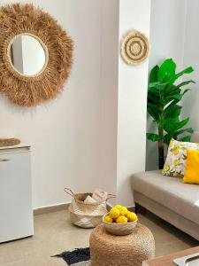 a living room with a mirror and a bowl of oranges at Hotel Imperial in Dhërmi