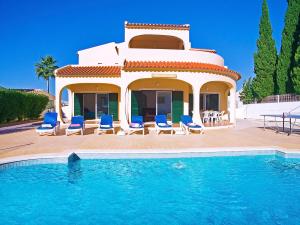 a villa with a swimming pool in front of a house at Villa La Romana by Algarve Vacation in Albufeira