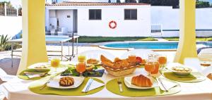 a table with food and a basket of bread on it at Villa La Romana by Algarve Vacation in Albufeira