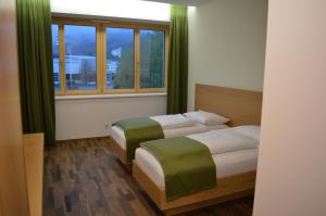 Posteľ alebo postele v izbe v ubytovaní Business Motel Feldkirch