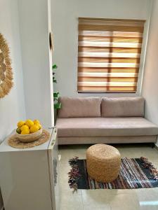 a living room with a couch and a bowl of fruit at Hotel Imperial in Dhërmi