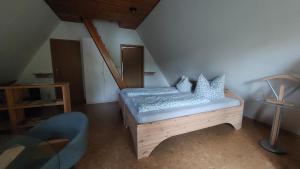 a bedroom with a bed with white pillows on it at Ferienwohnung zum Holzwurm in Friedersdorf