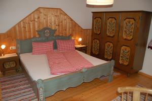 a bedroom with a bed with red pillows on it at Großberghof in Taxenbach