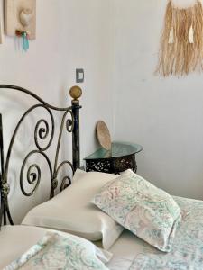a bedroom with two beds and a table with a lamp at Hotel Imperial in Dhërmi