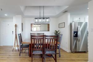 a dining room with a table and a refrigerator at Citadel 3728 in Sugar Mountain
