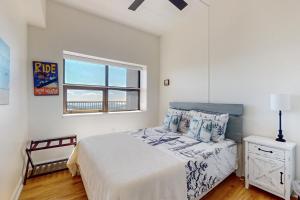 a white bedroom with a bed and a window at Citadel 3728 in Sugar Mountain +44 photos