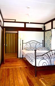 a bedroom with a bed and a wooden floor at Birdland Nature Resort - Vacation STAY 12454 in Akaoki