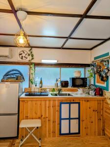 A kitchen or kitchenette at Birdland Nature Resort - Vacation STAY 12454
