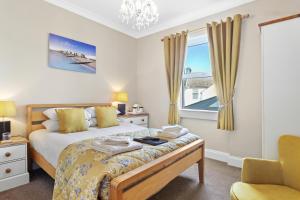 een slaapkamer met een bed en een raam bij Beach Front Guest House in Eastbourne